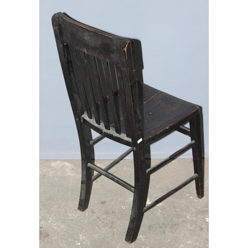 61 - An antique black painted slat back chair