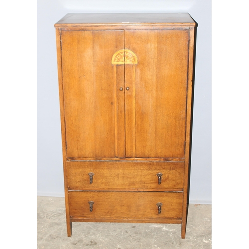 62 - An early 20th century oak, Arts & Crafts period hall cupboard with 3 shelves over 2 drawers, approx ... 