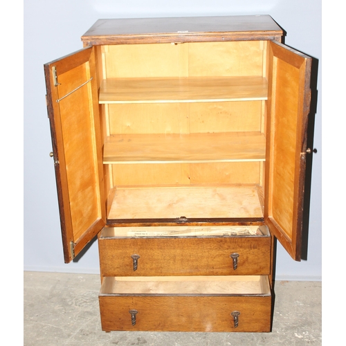 62 - An early 20th century oak, Arts & Crafts period hall cupboard with 3 shelves over 2 drawers, approx ... 