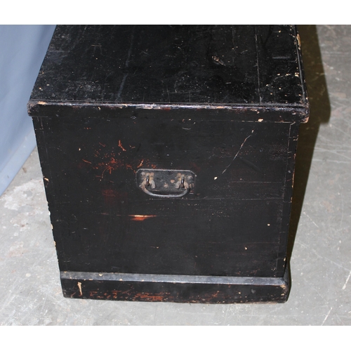 69 - An antique black painted pine trunk with iron fittings, approx 101cm wide x 45cm tall x 42cm deep