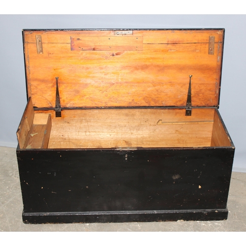 69 - An antique black painted pine trunk with iron fittings, approx 101cm wide x 45cm tall x 42cm deep