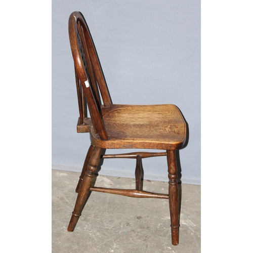 74 - An early 20th century oak wheelback kitchen chair