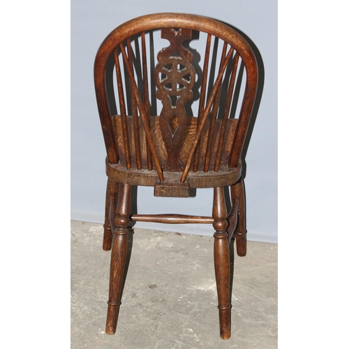 74 - An early 20th century oak wheelback kitchen chair