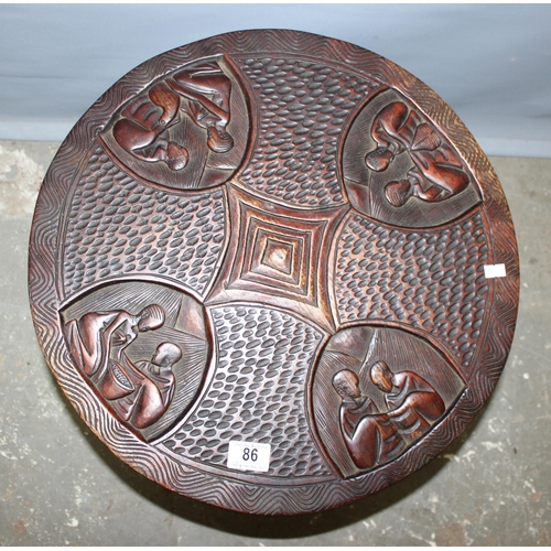 86 - An African carved wooden folding hardwood table, approx 50cm in diameter