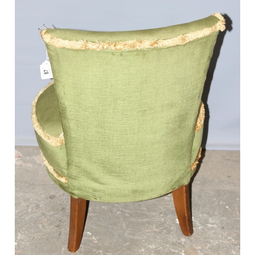 87 - A green velvet upholstered low chair