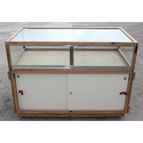 71 - A glazed pine counter display cabinet, approx 135cm wide x 98cm tall x 73cm deep