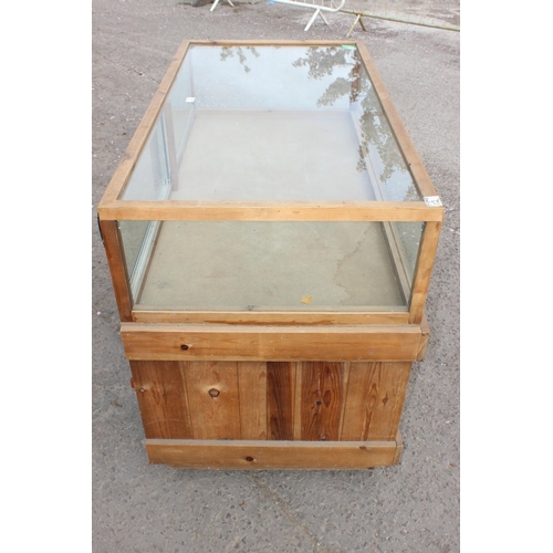 71 - A glazed pine counter display cabinet, approx 135cm wide x 98cm tall x 73cm deep