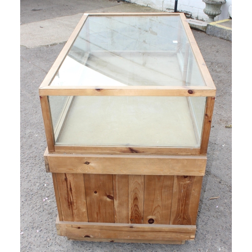 71 - A glazed pine counter display cabinet, approx 135cm wide x 98cm tall x 73cm deep