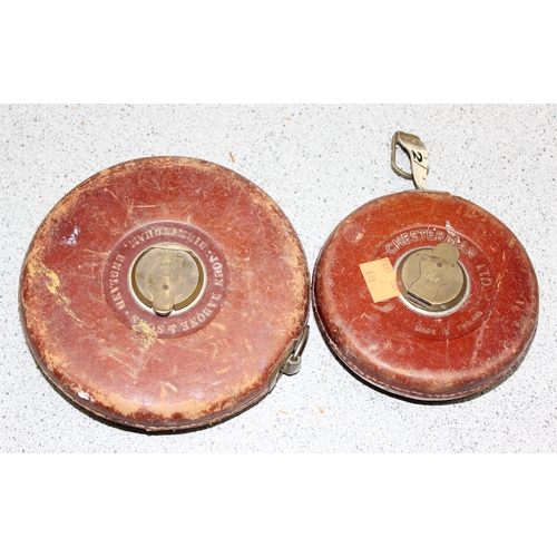 810 - An unusual drill and 2 vintage leather cased tape measures