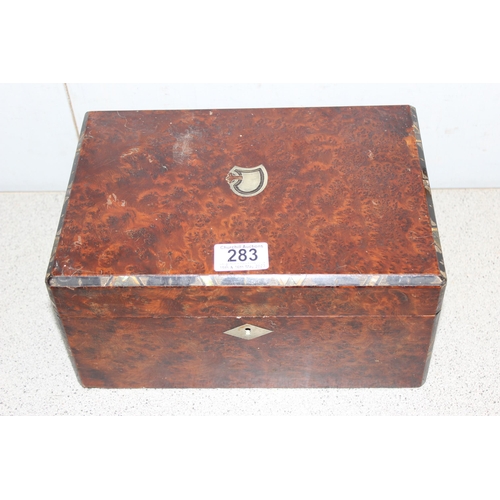 283 - An antique burrwood box with mother of pearl inlay