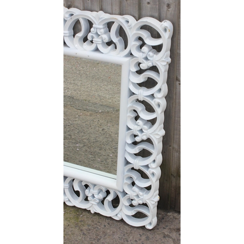 444 - A large decorative white framed mirror, approx 120cm x 95cm