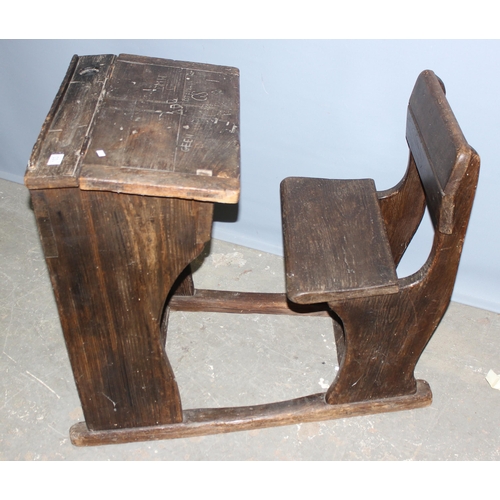 103 - An antique oak school desk with integrated seat, likely late 19th century, various interesting graff... 