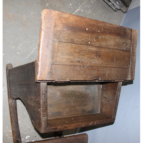 103 - An antique oak school desk with integrated seat, likely late 19th century, various interesting graff... 