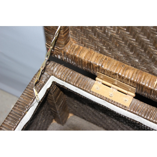 121 - A woven rattan storage box with wrought iron stand, approx 58cm wide