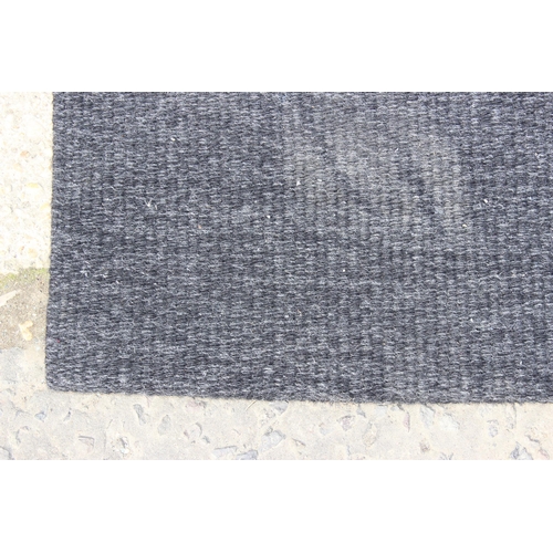 216 - A retro style black and beige striped flatweave rug, approx 390cm x 193cm