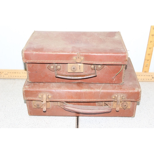 286 - A vintage travel trunk with labels, 2 small suitcases and a vintage leather and studded tool case