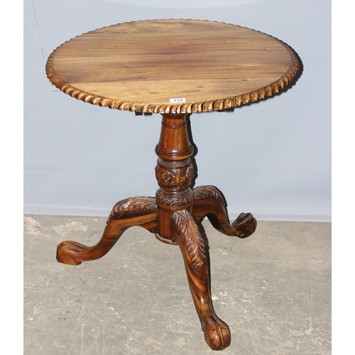 134 - An antique style tilt top table with carved details, approx 70cm in diameter