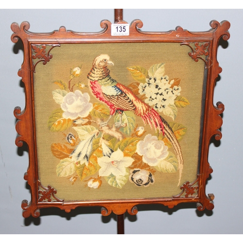 135 - An antique mahogany framed pole screen with tapestry panel depicting a pheasant in naturalistic sett... 