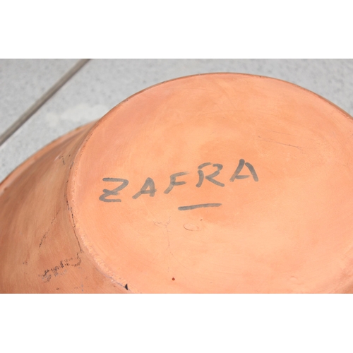 1805 - A large decorative terracotta bowl marked Zafra on iron stand and an indistinctly signed Art Pottery... 