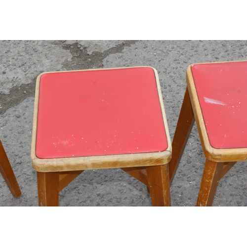 141 - Set of five retro light wood & red seated leatherette stools by Stoe, approx 57cm tall