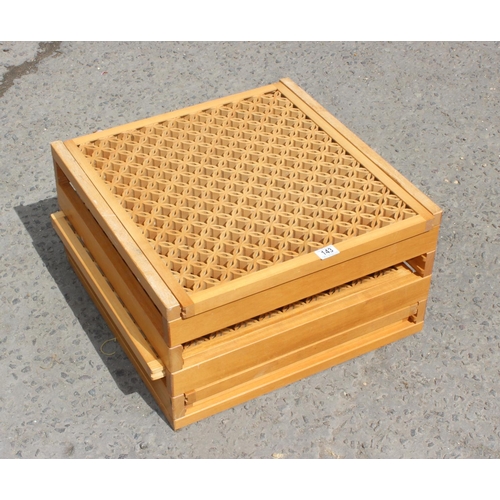 143 - Lightwood latticed coffee table with sliding internal shelves, 55cm wide 30cm high