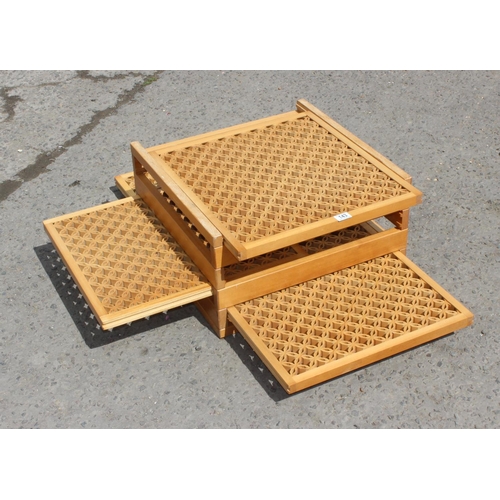 143 - Lightwood latticed coffee table with sliding internal shelves, 55cm wide 30cm high