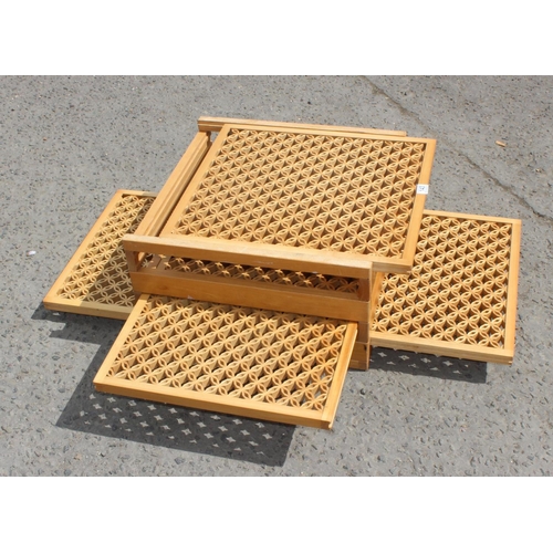 143 - Lightwood latticed coffee table with sliding internal shelves, 55cm wide 30cm high