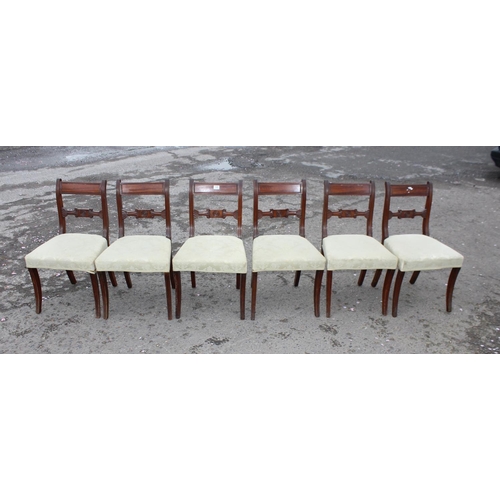 105 - A set of 6 antique mahogany rail back dining chairs standing on sabre legs with stuffed and upholste... 