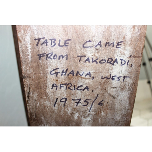 144 - A vintage West African wooden coffee table with carved elephant supports, approx 114cm wide