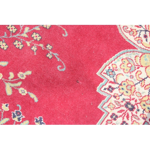 220 - An extremely large decorative red ground rug, approx 380cm x 270cm