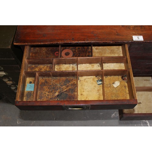 5 - A late Victorian mahogany haberdashery shop bank of fourteen drawers, each graduated drawer with flu... 