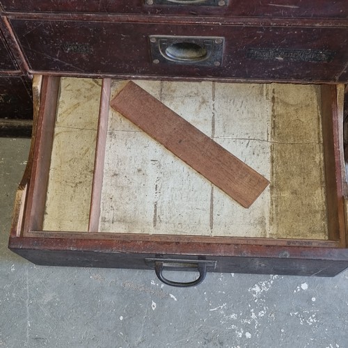 5 - A late Victorian mahogany haberdashery shop bank of fourteen drawers, each graduated drawer with flu... 