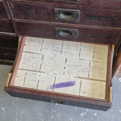 5 - A late Victorian mahogany haberdashery shop bank of fourteen drawers, each graduated drawer with flu... 