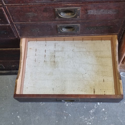 5 - A late Victorian mahogany haberdashery shop bank of fourteen drawers, each graduated drawer with flu... 