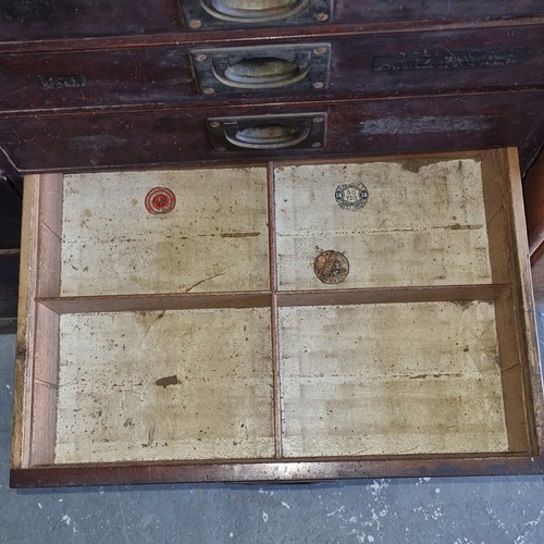 5 - A late Victorian mahogany haberdashery shop bank of fourteen drawers, each graduated drawer with flu... 