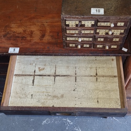 5 - A late Victorian mahogany haberdashery shop bank of fourteen drawers, each graduated drawer with flu... 