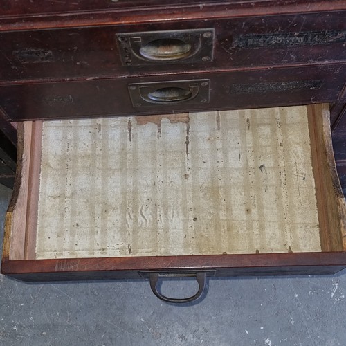 5 - A late Victorian mahogany haberdashery shop bank of fourteen drawers, each graduated drawer with flu... 