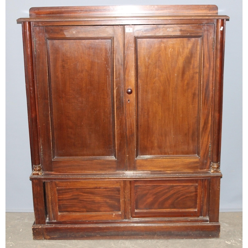 18 - A late 19th century mahogany hall cupboard with 2 shelves in the upper section over a lower cupboard... 