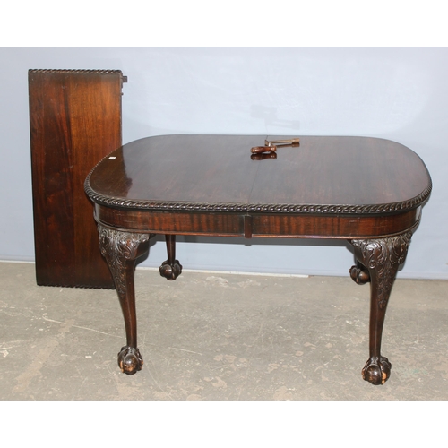 11 - An impressive late 19th or early 20th century mahogany table with extra leaf and original winding ha... 