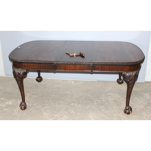 11 - An impressive late 19th or early 20th century mahogany table with extra leaf and original winding ha... 