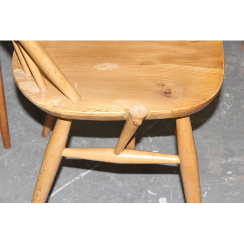 2 - A set of 4 retro blonde Ercol hoop back dining chairs, 1 dining chairs and 3 carvers, one of which h... 