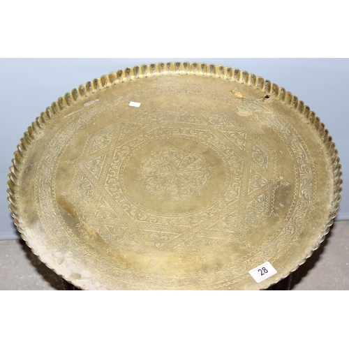 28 - A vintage brass topped Benares table with folding wooden and inlaid base, approx 59cm in diameter