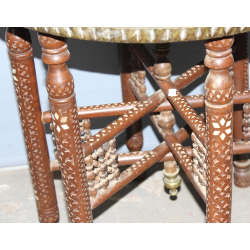 28 - A vintage brass topped Benares table with folding wooden and inlaid base, approx 59cm in diameter