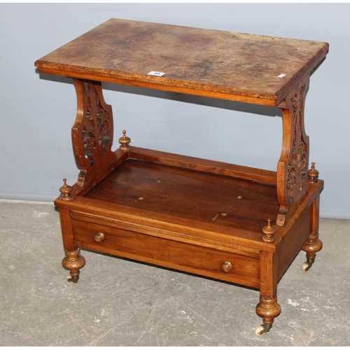 44 - A 19th century walnut side table with single drawer, standing on brass and ceramic castors with carv... 