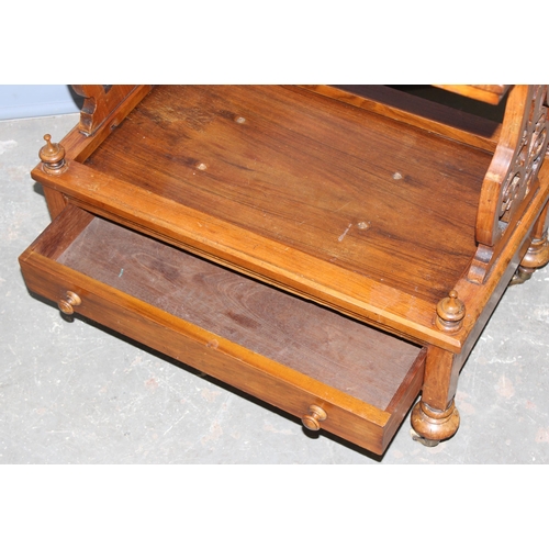 44 - A 19th century walnut side table with single drawer, standing on brass and ceramic castors with carv... 