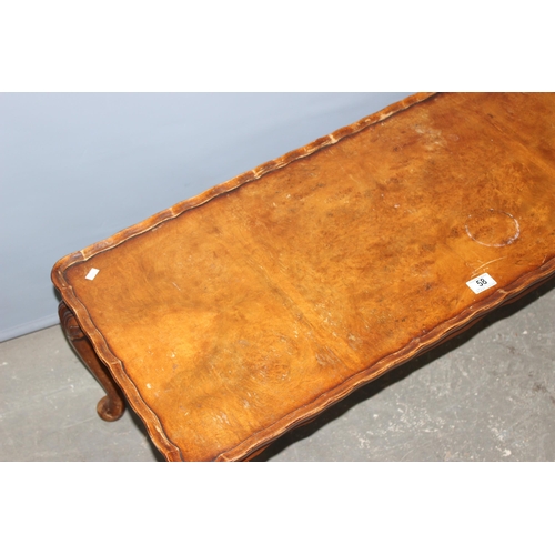 58 - An early 20th century low table with pie crust edge and carved cabriole legs, approx 106cm x 44cm