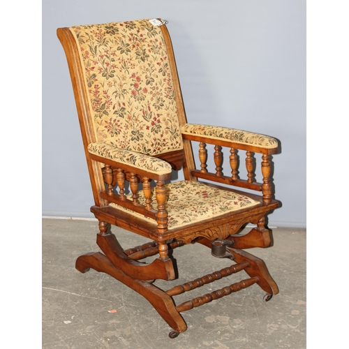 67 - A 19th century American rocking chair with cream and patterned floral upholstery