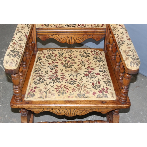 67 - A 19th century American rocking chair with cream and patterned floral upholstery