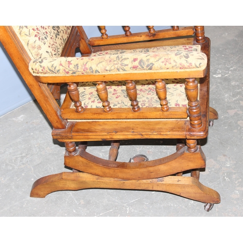 67 - A 19th century American rocking chair with cream and patterned floral upholstery