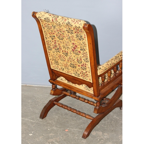 67 - A 19th century American rocking chair with cream and patterned floral upholstery